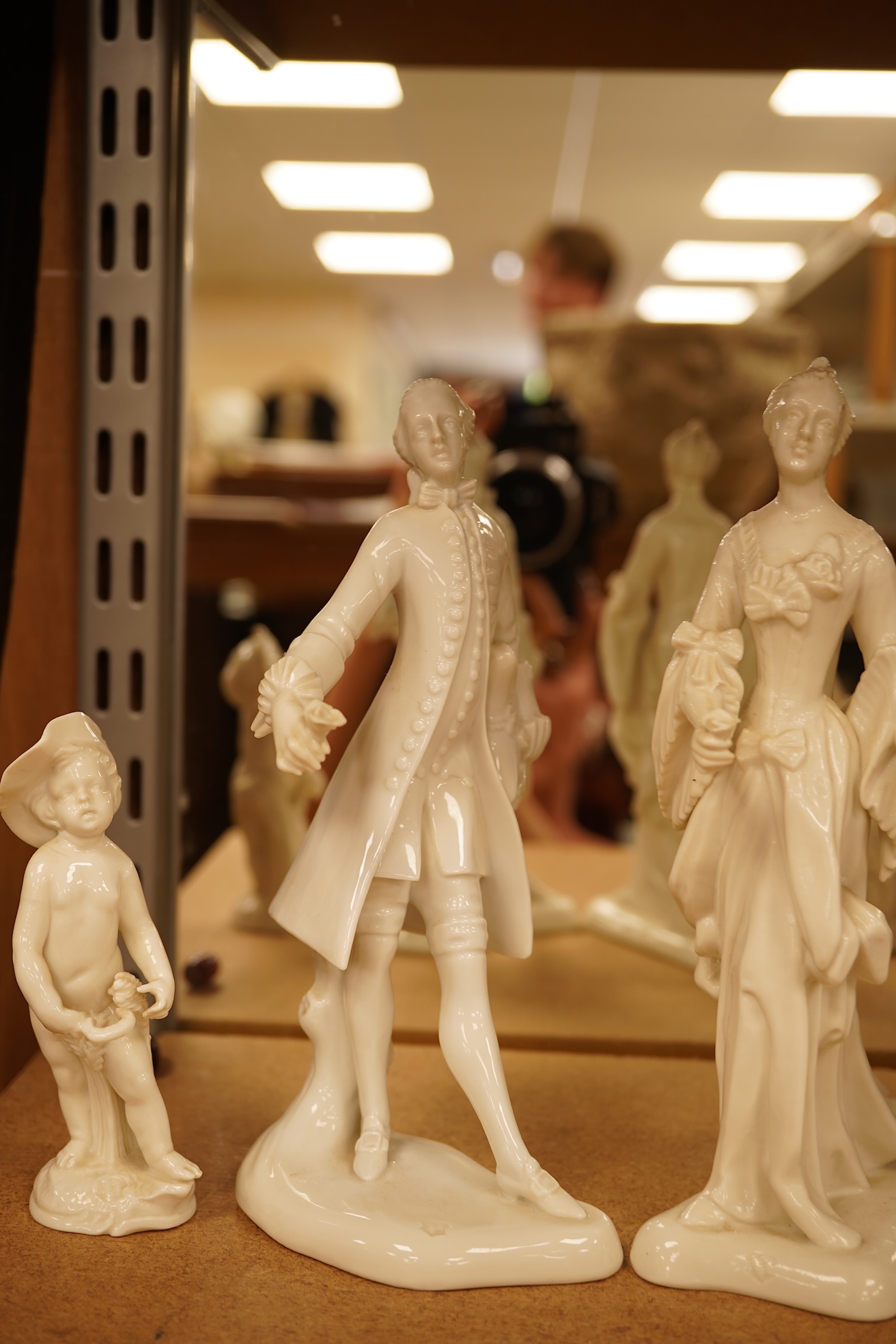 Two Nymphenberg white glazed figures, after Bustelli and two similar cherubs (4) figure 19 cm high